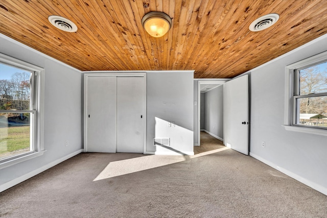 unfurnished bedroom featuring carpet and wood ceiling
