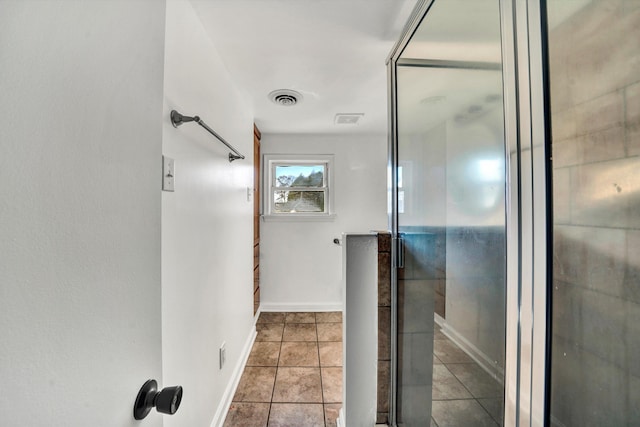 bathroom with a shower and tile patterned floors