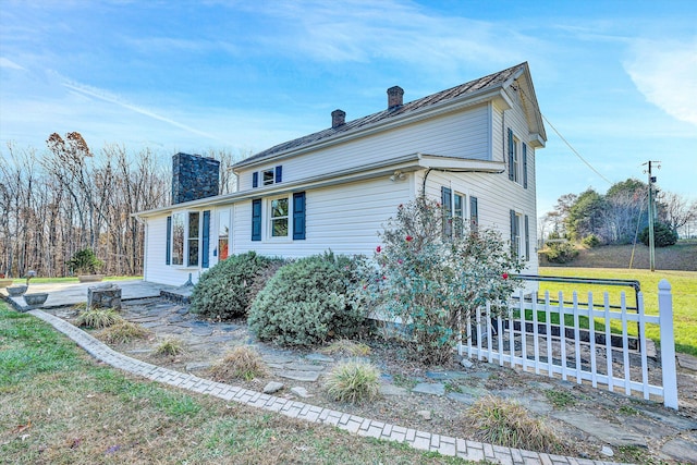 view of home's exterior with a yard
