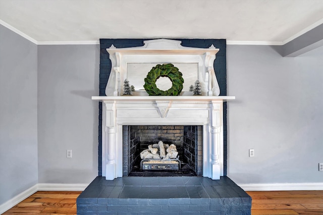 interior details with hardwood / wood-style floors, ornamental molding, and a brick fireplace