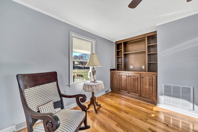 sitting room featuring ceiling fan and light wood-type flooring