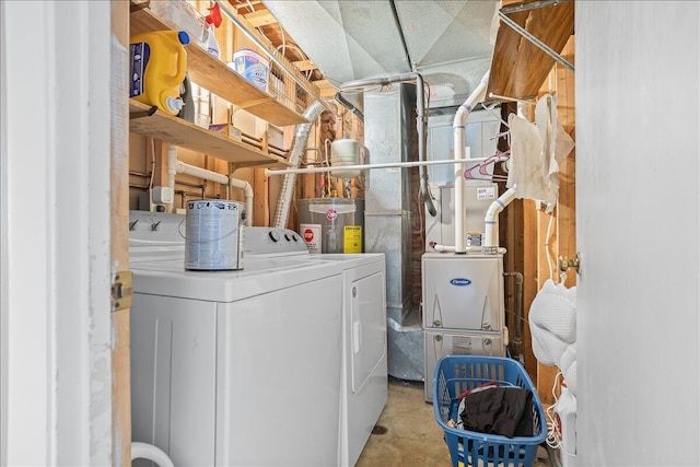 washroom with electric water heater and washer and dryer