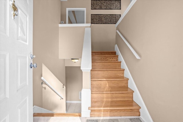 stairs featuring tile patterned floors