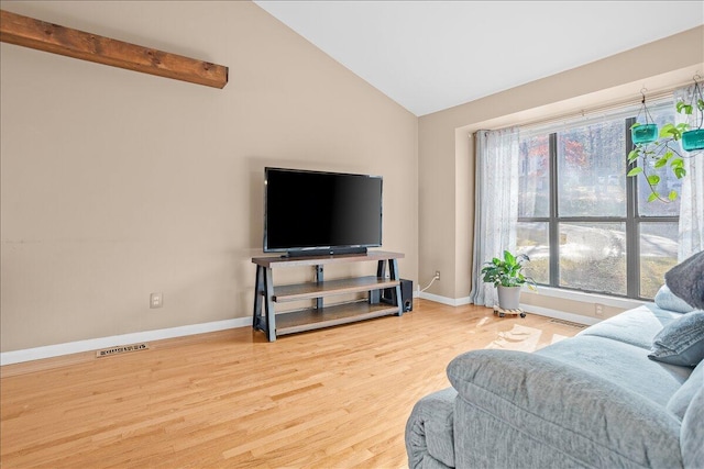 living room with hardwood / wood-style floors and lofted ceiling