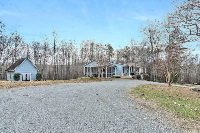 view of front of house featuring a porch, an outdoor structure, and a garage