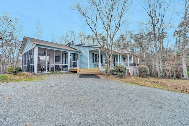 view of front facade featuring covered porch and a sunroom