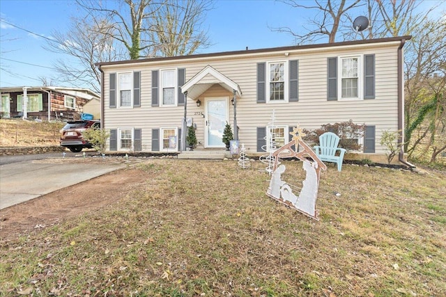 bi-level home with a front lawn