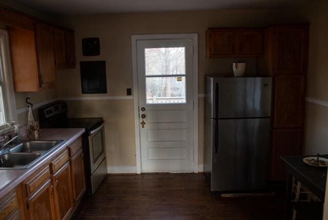 kitchen featuring sink, appliances with stainless steel finishes, and dark wood-type flooring