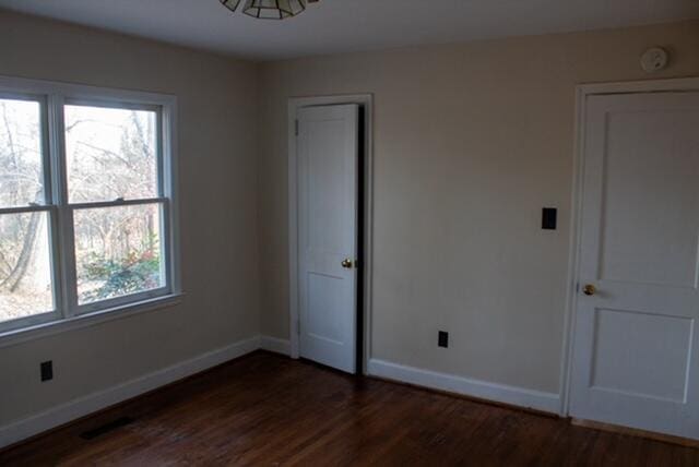 unfurnished bedroom featuring dark hardwood / wood-style floors