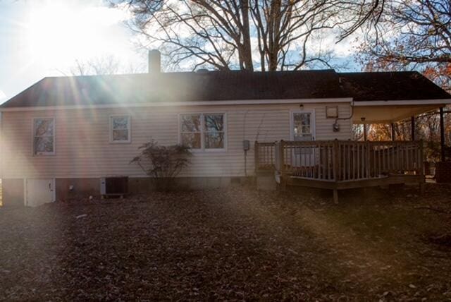 rear view of house featuring a wooden deck and central AC