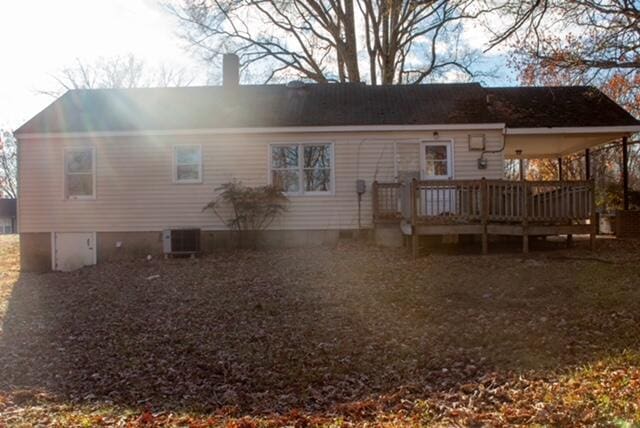 back of property with a wooden deck and central AC unit