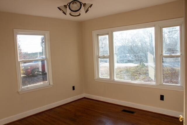 unfurnished room featuring dark hardwood / wood-style floors