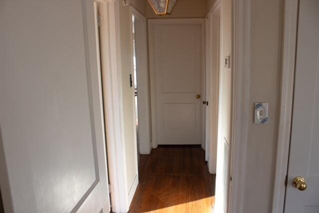 hall with dark wood-type flooring