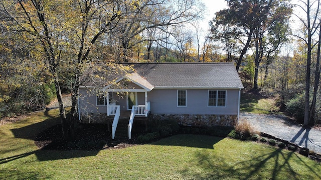 view of front of home with covered porch and a front yard