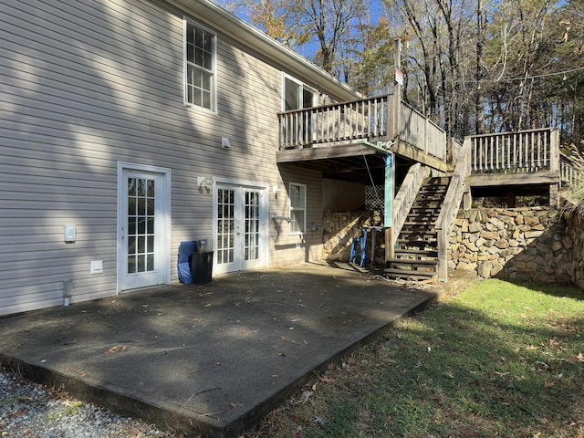 rear view of house with french doors, a patio, and a deck