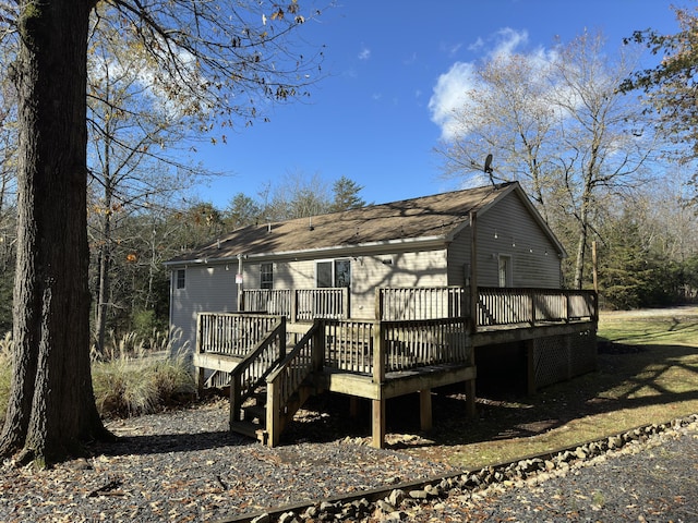 rear view of house featuring a wooden deck