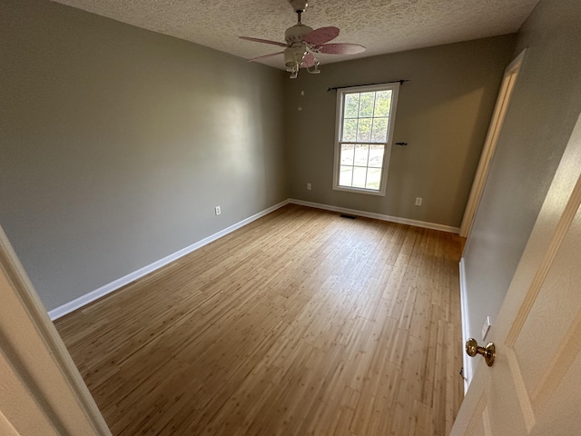 unfurnished room featuring hardwood / wood-style floors, a textured ceiling, and ceiling fan