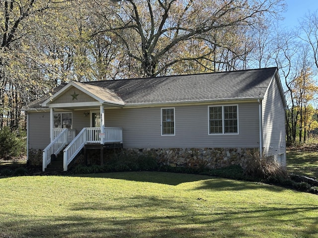 view of front of home with covered porch and a front yard