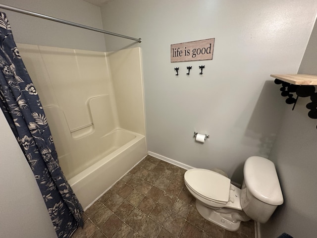 bathroom featuring shower / bath combo and toilet