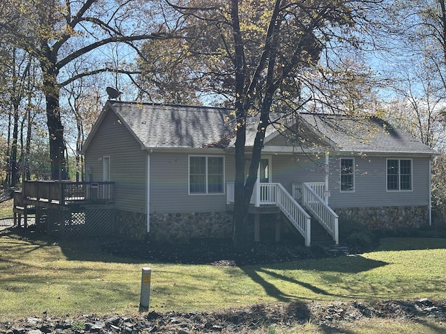 back of property featuring a yard and a wooden deck