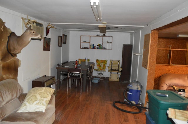 dining room featuring dark hardwood / wood-style floors and an AC wall unit