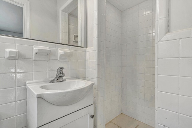 bathroom featuring tile walls and vanity