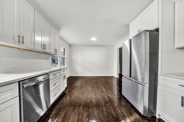 kitchen with dark hardwood / wood-style flooring, white cabinetry, dishwasher, and sink