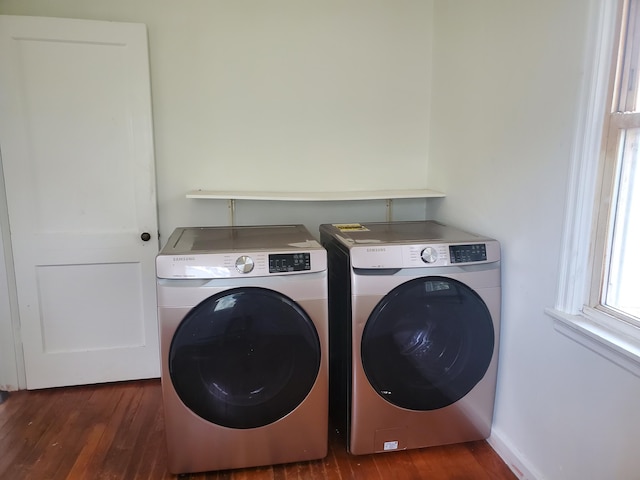 laundry room with separate washer and dryer, laundry area, and dark wood finished floors