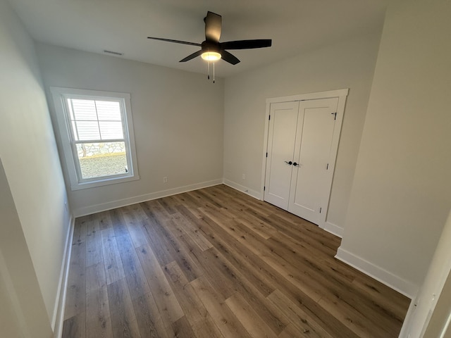 spare room with ceiling fan and wood-type flooring