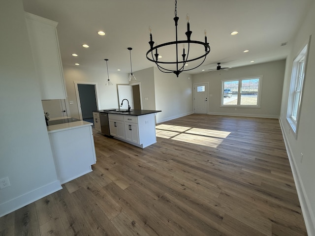 kitchen featuring dishwasher, dark hardwood / wood-style flooring, white cabinets, and hanging light fixtures