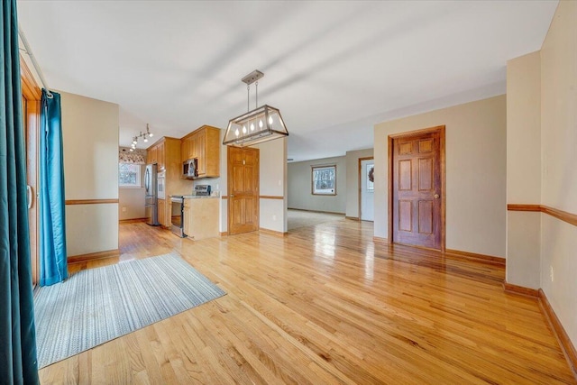 unfurnished living room with light hardwood / wood-style flooring