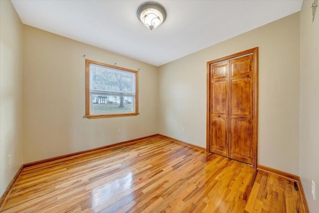 unfurnished bedroom with light wood-type flooring