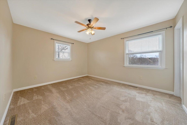 carpeted spare room featuring ceiling fan