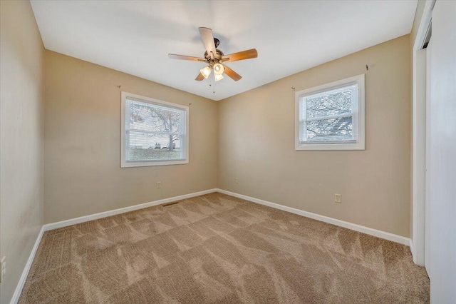 empty room with light carpet and ceiling fan