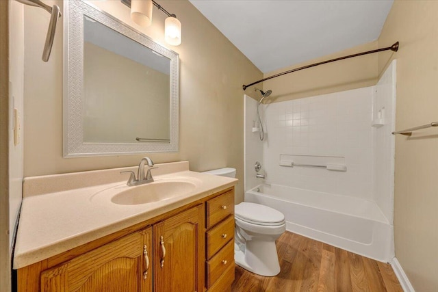 full bathroom featuring hardwood / wood-style floors, vanity, shower / bathtub combination, and toilet