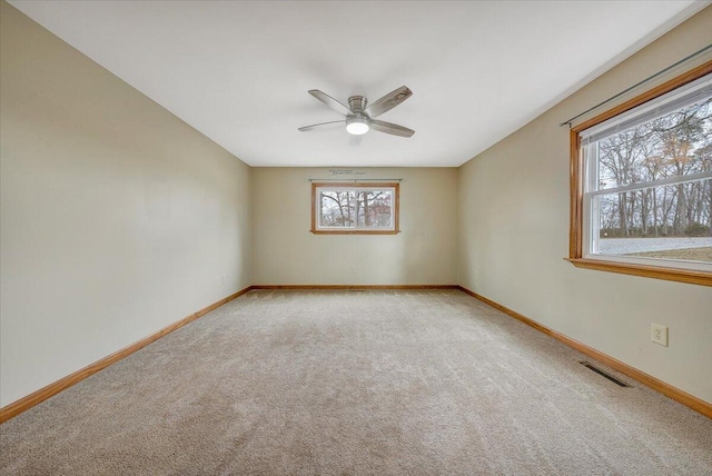 empty room featuring carpet flooring and ceiling fan