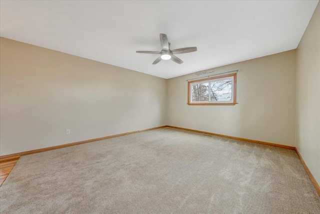 empty room with light colored carpet and ceiling fan