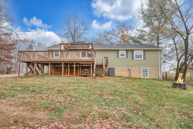 back of house featuring a lawn, central AC unit, and a deck