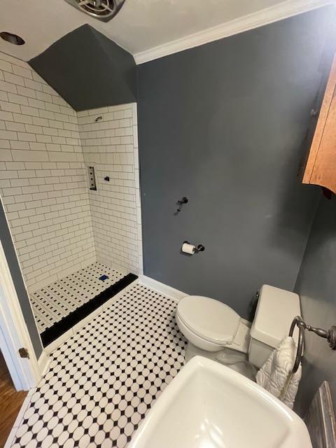 bathroom with toilet, vanity, and crown molding