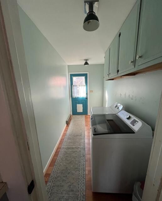 full bathroom with toilet, tiled shower / bath combo, baseboard heating, crown molding, and vanity