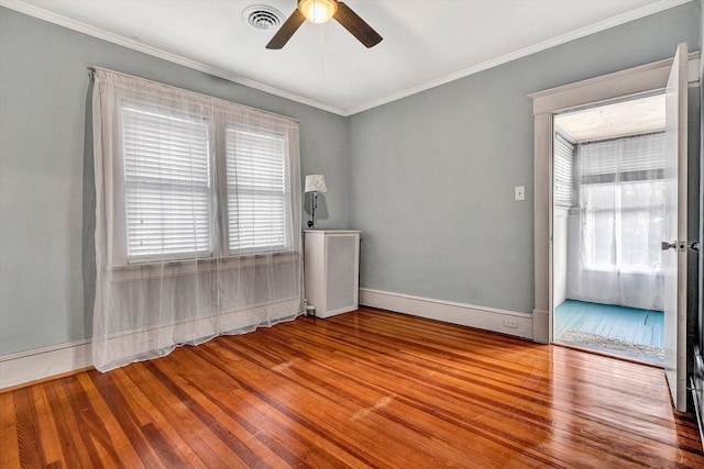 unfurnished room with ceiling fan, light hardwood / wood-style flooring, and crown molding