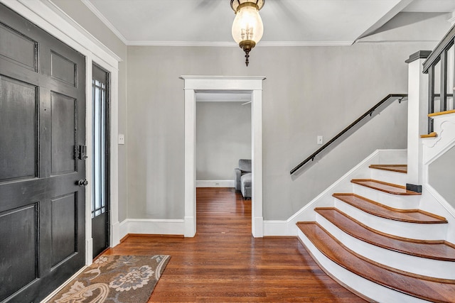 entryway with plenty of natural light, dark hardwood / wood-style floors, and crown molding