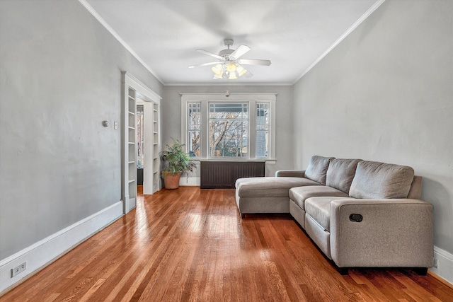 living room featuring ceiling fan, radiator, ornamental molding, and hardwood / wood-style flooring