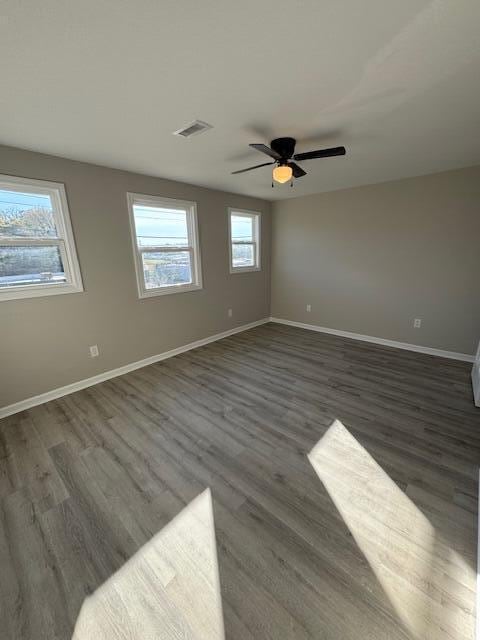 unfurnished room featuring ceiling fan and dark wood-type flooring