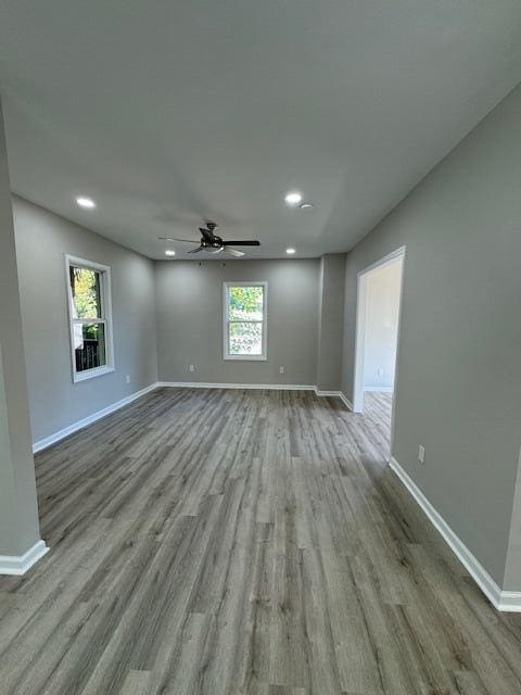 empty room featuring light wood-type flooring and ceiling fan