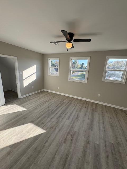 empty room featuring ceiling fan and hardwood / wood-style flooring