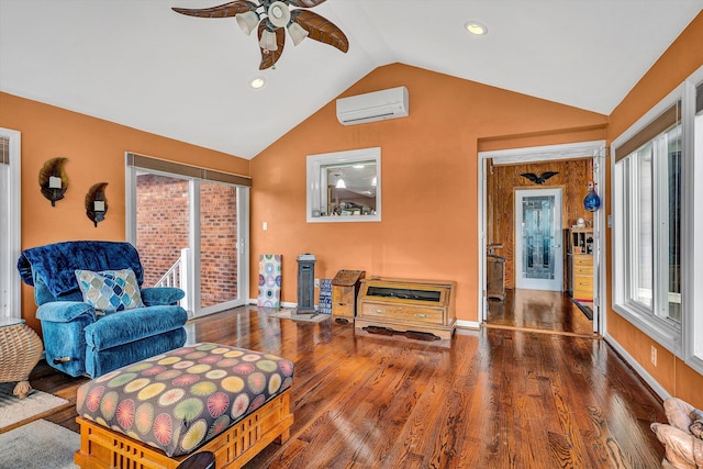 living area featuring ceiling fan, lofted ceiling, dark wood-type flooring, and a wall unit AC