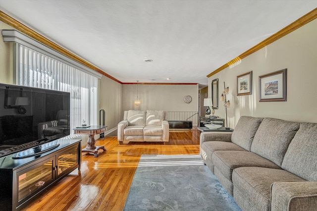 living room with hardwood / wood-style flooring and ornamental molding