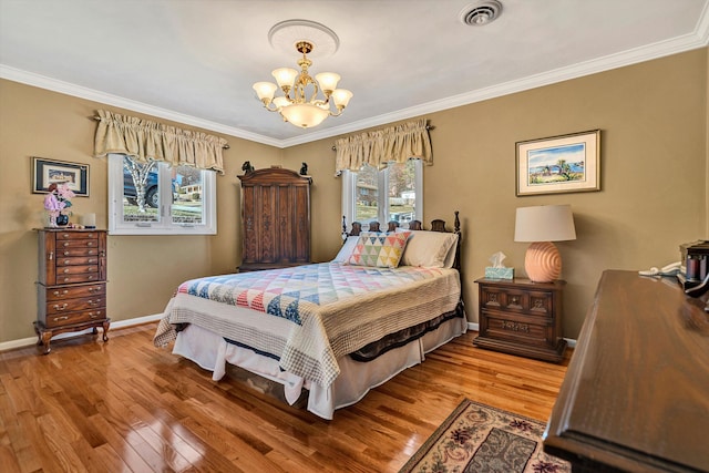 bedroom with crown molding, hardwood / wood-style floors, and a notable chandelier