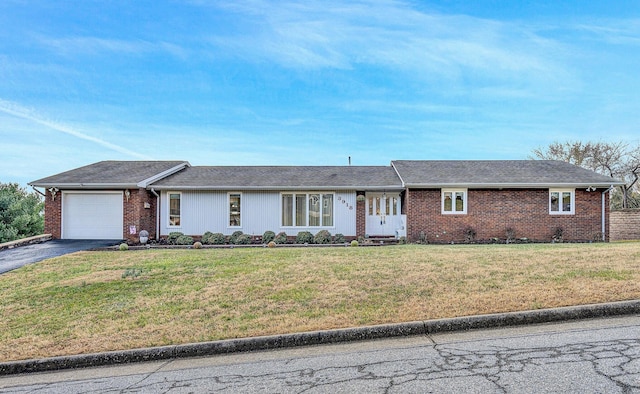 ranch-style home with a garage and a front yard